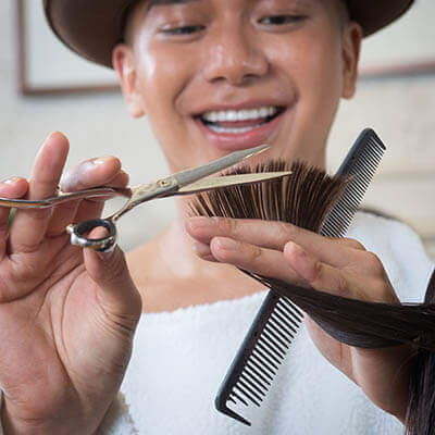 Hair stylist cutting a person's hair